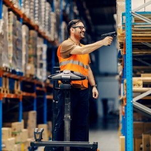 logistic worker in warehouse scanning goods