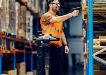 logistic worker in warehouse scanning goods