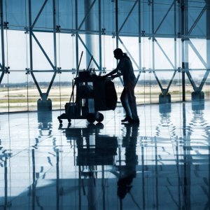 Cleaner with a trolley full of equipment