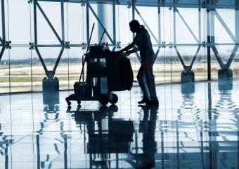 Cleaner with a trolley full of equipment